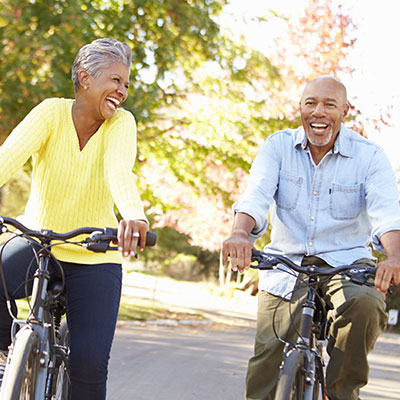 elderly couple on a bike